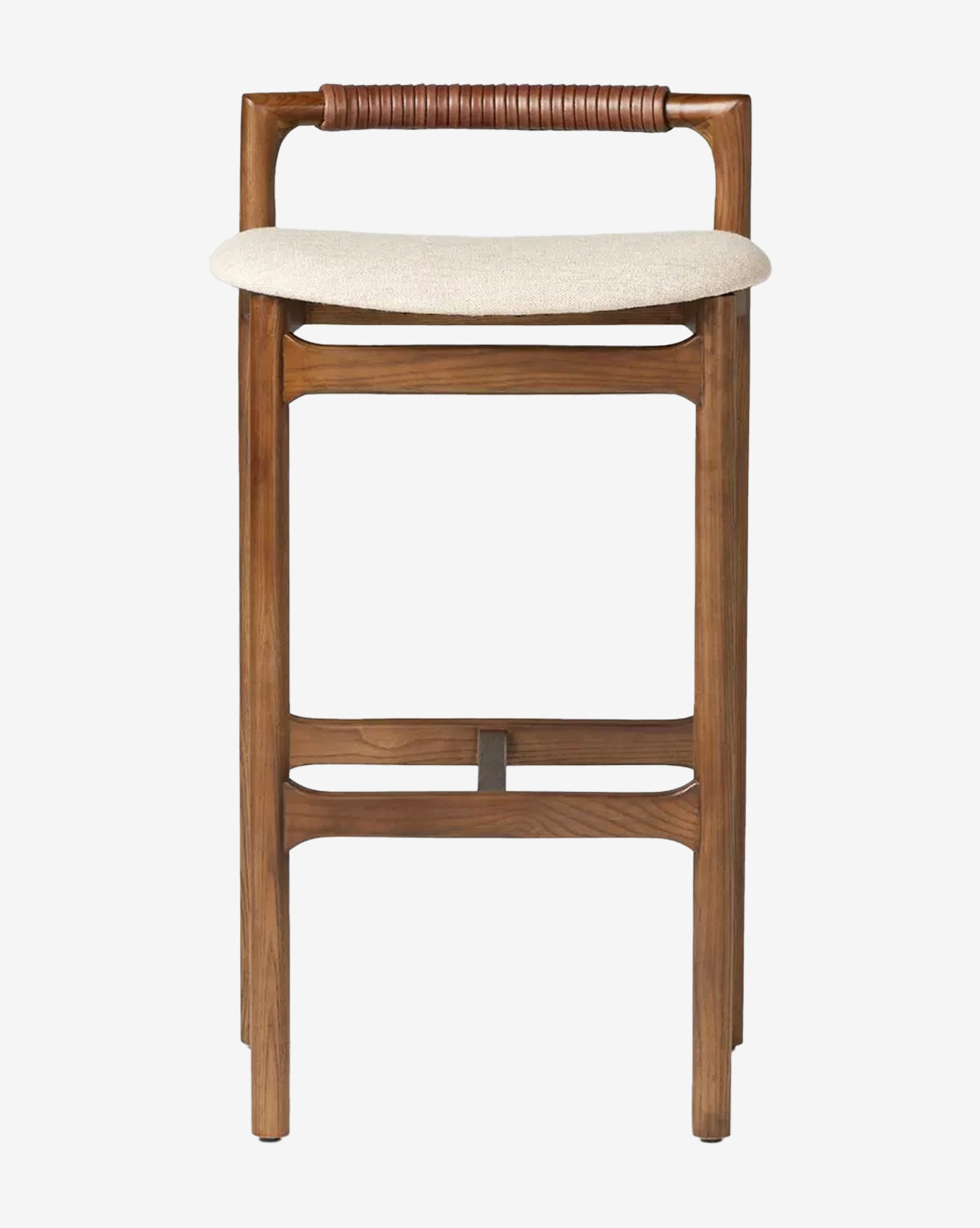 The Four Hands Patrin Stool boasts a modern ash wood frame, a light performance-upholstered seat, dark brown leather-wrapped rounded backrest, and straight wooden legs with footrests for minimalist style. McGee & Co.