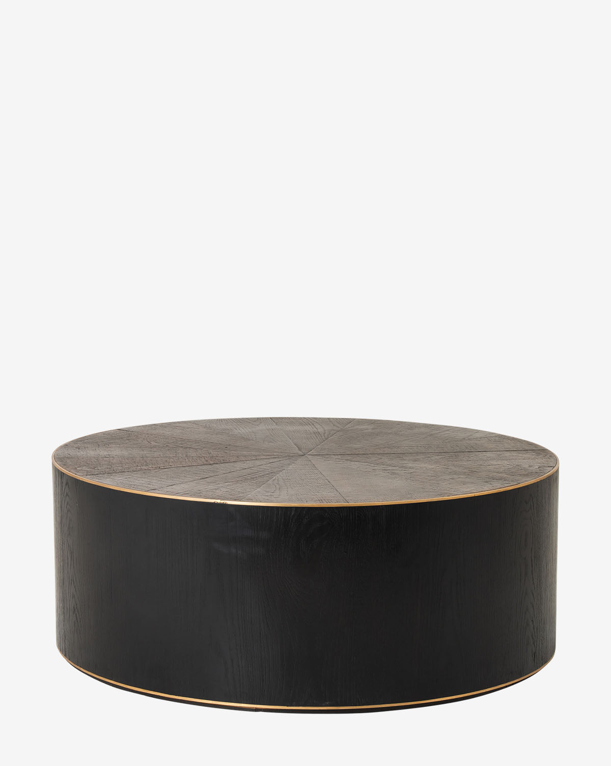 The Paxton Coffee Table is a round, black wooden piece with a flat top, smooth sides, and minimalist modern design. It features a distressed brass ring accent and is shown against a plain white background by McGee & Co.