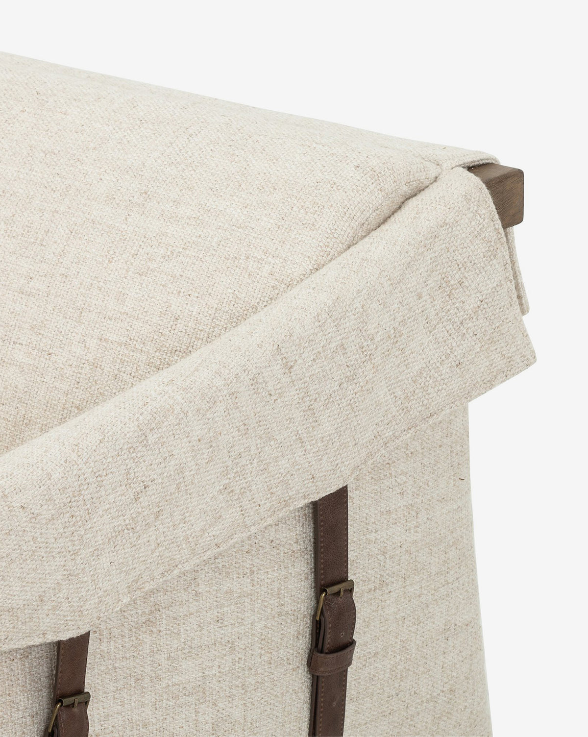 Close-up of Payson Leather Chair in beige performance fabric with top-grain leather straps and buckles, highlighting the textured surface and part of the seat against a white background.