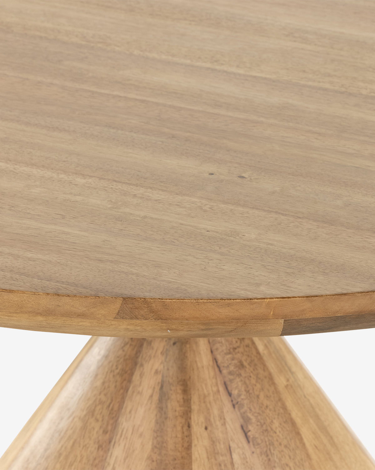 A close-up of the Pedretti Dining Table highlights its smooth, natural wood grain surface and sturdy tapered pedestal base, exemplifying the timeless elegance of Italian design, by McGee & Co.