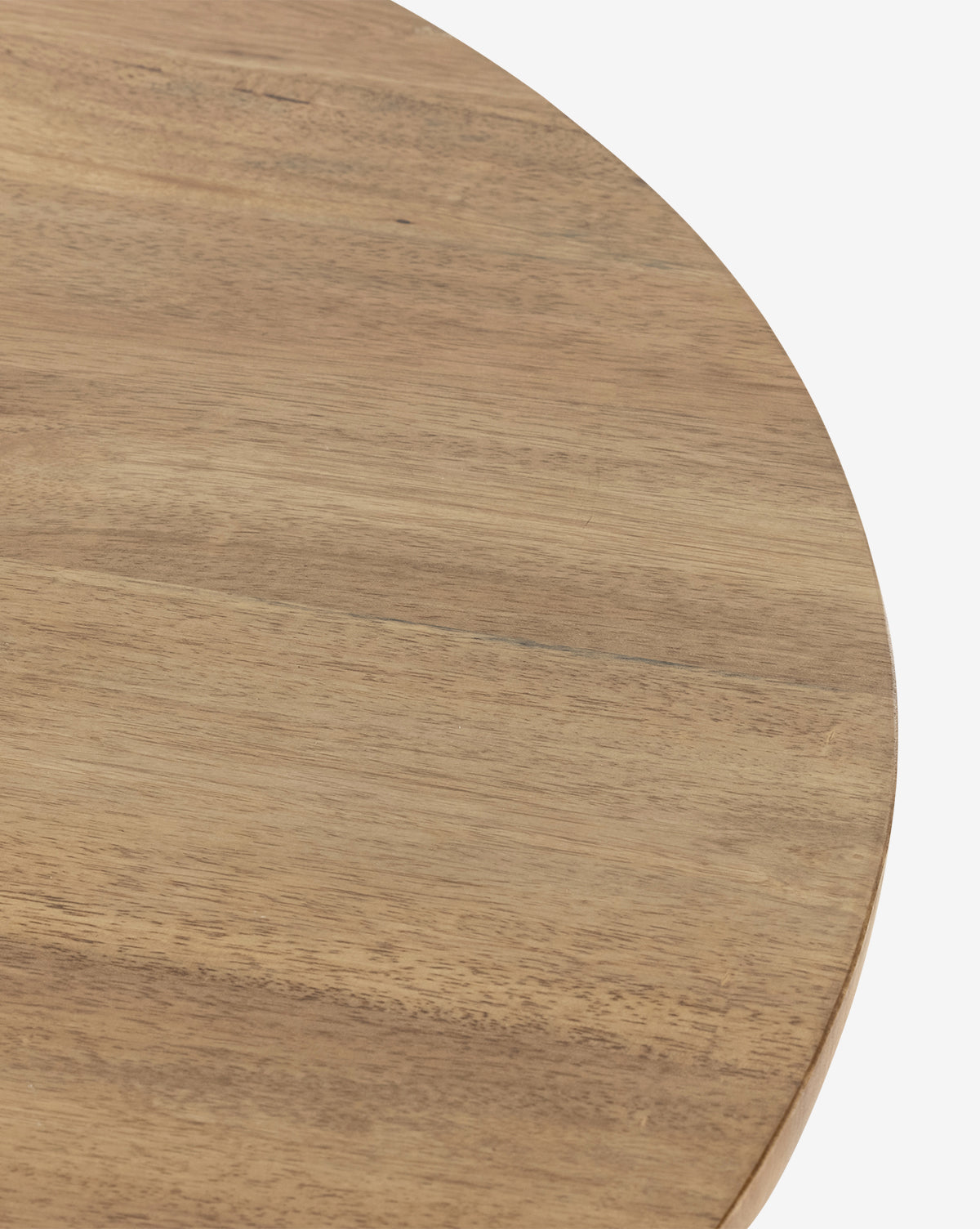 A close-up of the Pedretti Dining Table shows its round, light brown tabletop with a smooth finish and natural wood grain, by McGee & Co.