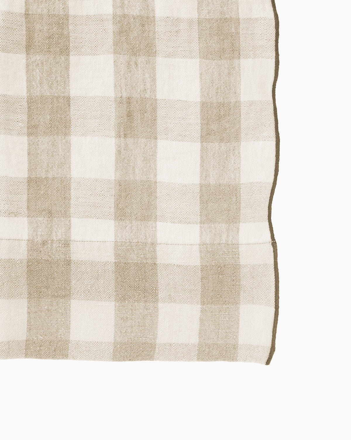 A close-up of the Pennie Shower Curtain in beige and white checkered pattern, featuring a neatly sewn edge on the right side, set against a white background.
