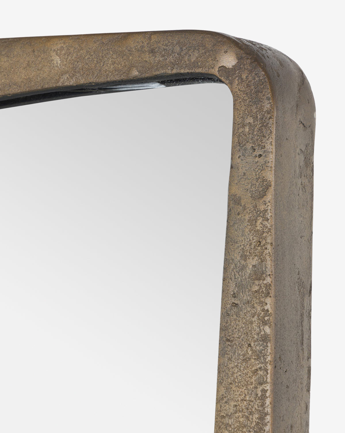 Close-up of the top corner of the Penrod Floor Mirror, featuring a thick, rustic cast aluminum frame ideal for sculptural home decor, set against a white background, by McGee & Co.