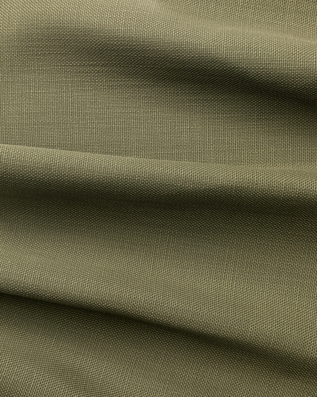 Close-up of olive green Perennials Upholstery Swatch featuring a textured, woven surface with gentle horizontal folds. This solution-dyed acrylic performance fabric ensures long-lasting beauty and durability.