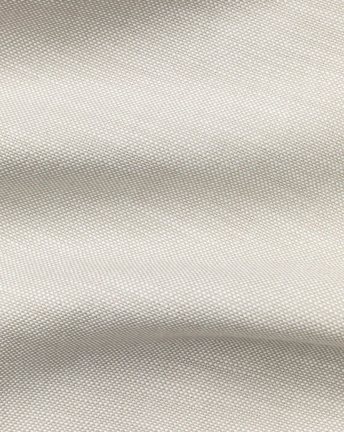 Close-up of the Perennials Upholstery Swatch in light beige, featuring a subtle woven texture and gentle folds that highlight the softness and smooth feel typical of performance fabrics.