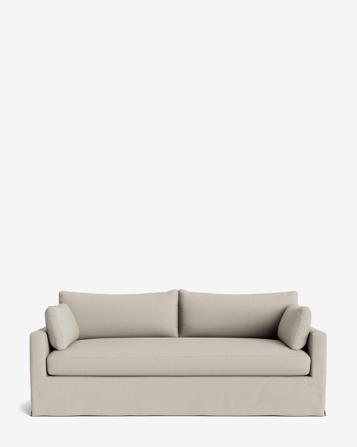 The Peterson Classic Slipcover Sofa (75-100) in light beige has two seat and back cushions, feather blend filling, and cylindrical bolster pillows, shown against a plain white background by McGee & Co.