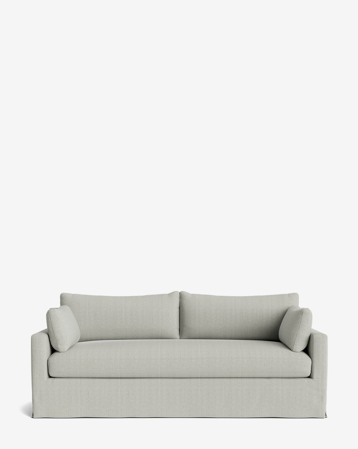 A modern light gray Peterson Classic Slipcover Sofa (75-100) with straight lines, feather blend cushions, and two cylindrical side pillows, set against a plain white background by McGee & Co.