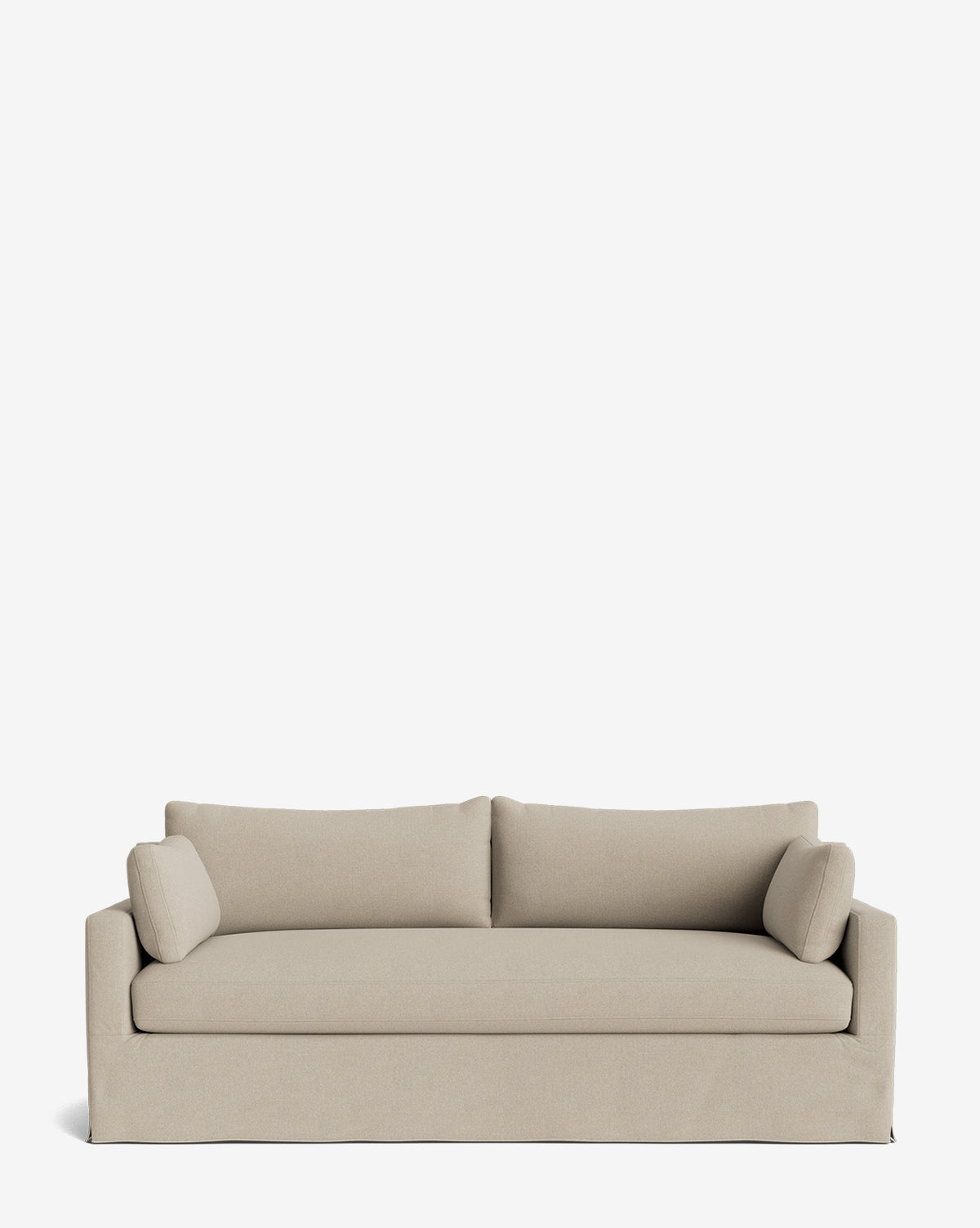 A modern Peterson Classic Slipcover Sofa (75-100) in light beige, featuring clean lines, two feather blend seat cushions, two back cushions, and matching cylindrical pillows, set against a plain white background by McGee & Co.