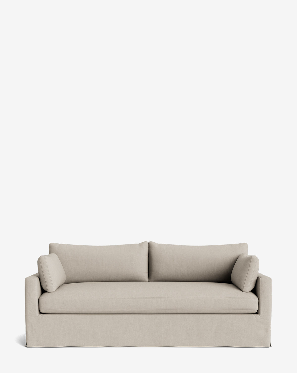 The Peterson Classic Slipcover Sofa (75-100) in light beige features clean lines, feather blend cushions, two cylindrical side pillows, and a tailored skirt, set against a plain white background by McGee & Co.