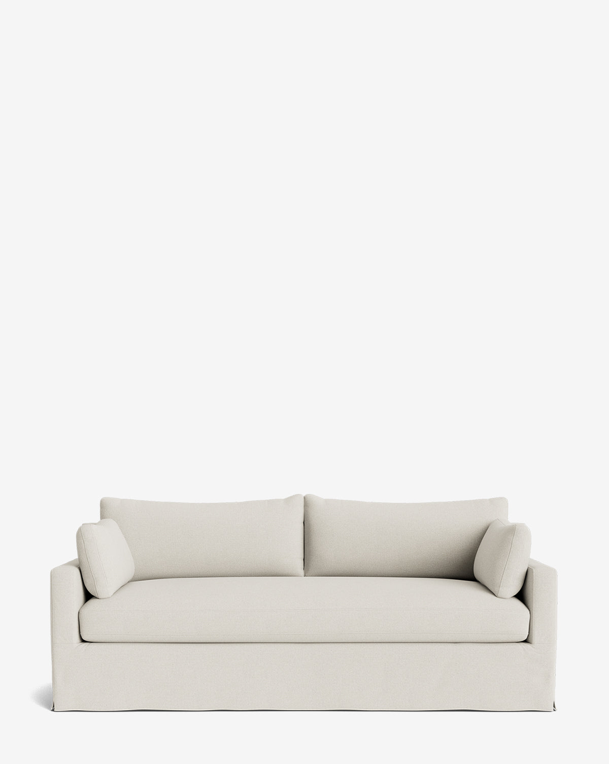 A modern Peterson Classic Slipcover Sofa (75-100) in light beige features straight lines, two back cushions, and two cylindrical side pillows with feather blend cushions, displayed against a plain white background by McGee & Co.