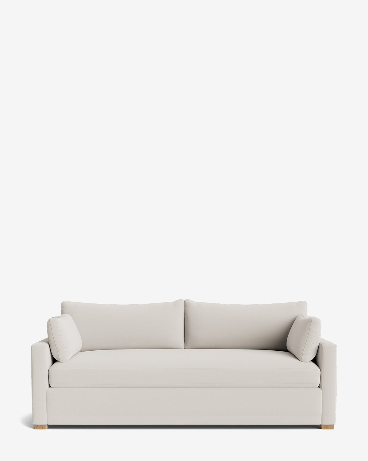 The Peterson Classic Upholstered Sofa (75 - 100) features light beige upholstery, plush seat and back cushions, two matching side pillows, straight armrests, and wooden block feet for comfort and timeless style, by McGee & Co.