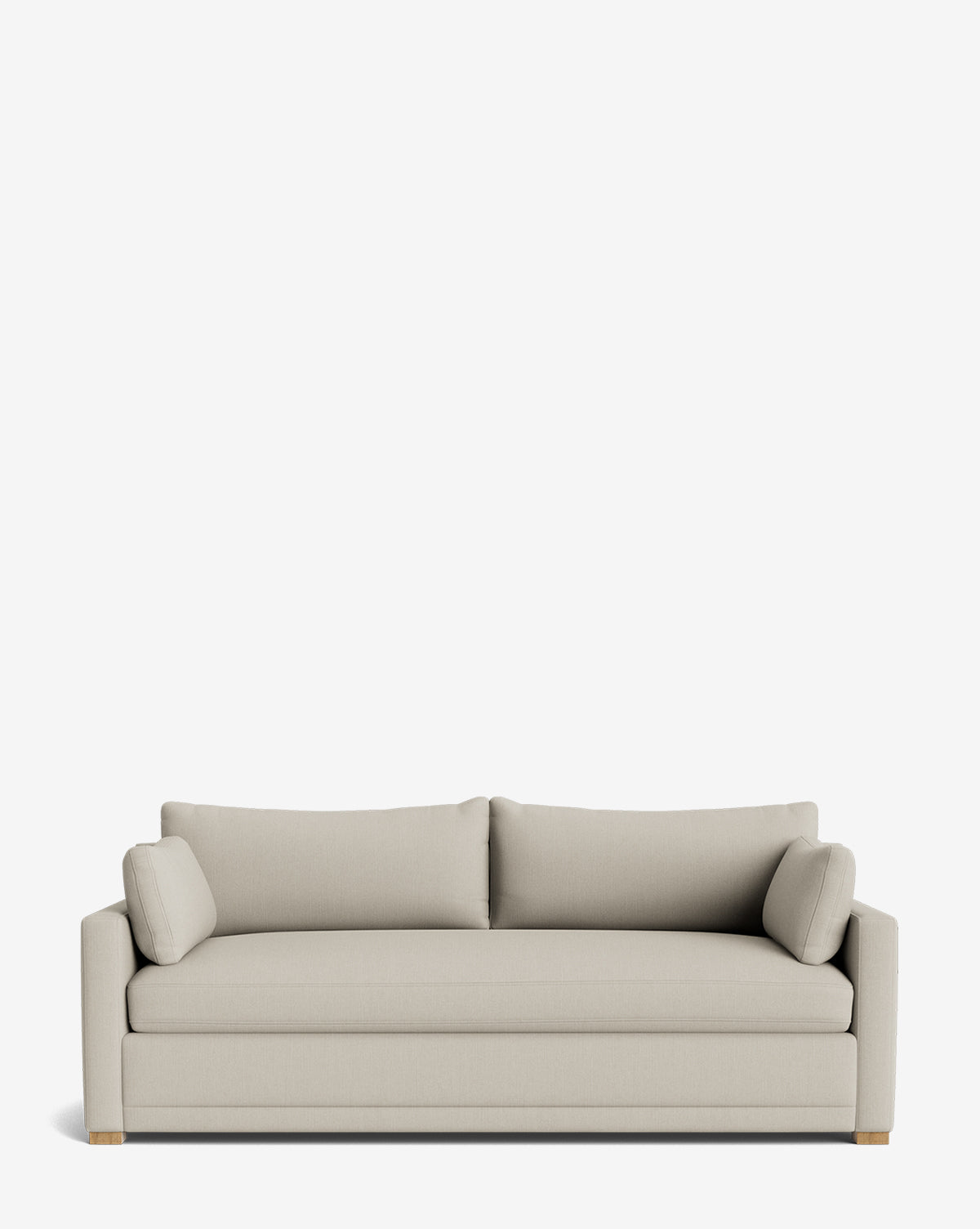 The Peterson Classic Upholstered Sofa (75 - 100) features modern light beige upholstery, straight arms, plush seat and back cushions, and two cylindrical bolster pillows, shown against a plain white background by McGee & Co.