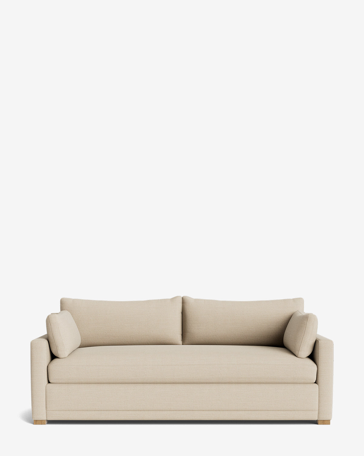 The Peterson Classic Upholstered Sofa (75 - 100) in modern beige features plush cushions, two matching back cushions, square arms, and includes two cylindrical bolster pillows, displayed against a plain white background by McGee & Co.