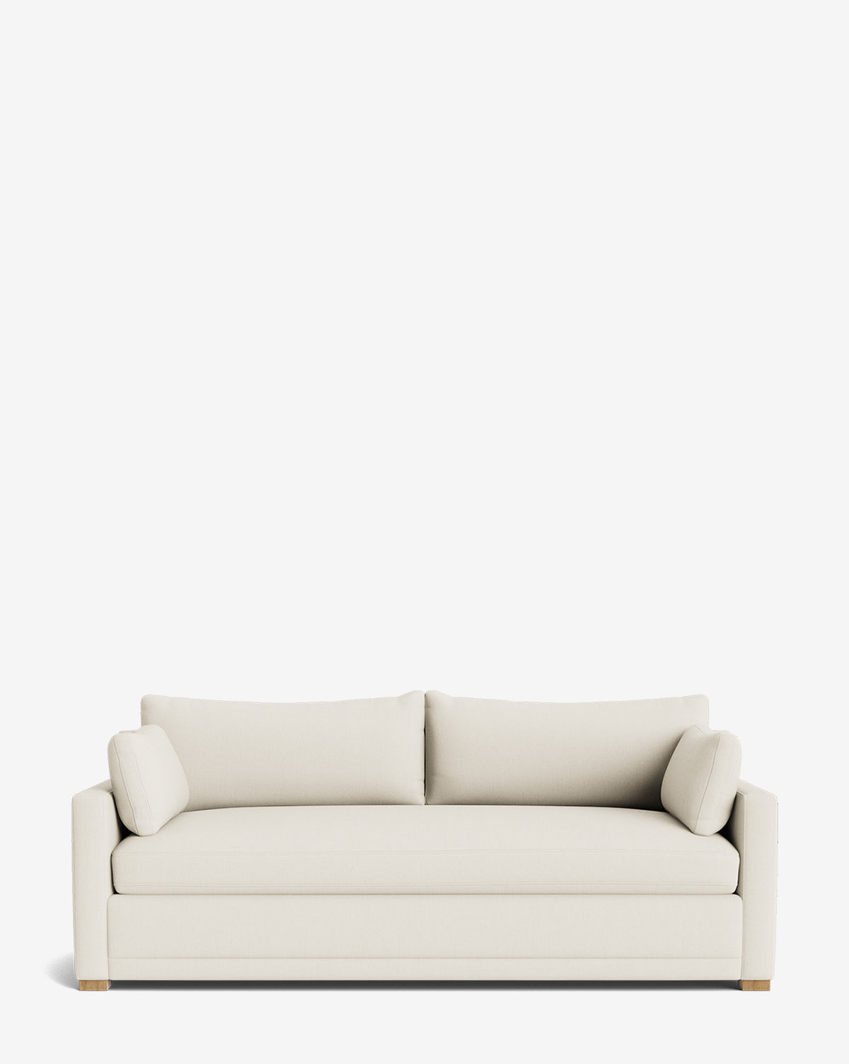 The Peterson Classic Upholstered Sofa (75 - 100) is a modern light beige piece with plush cushions, two matching rectangular back cushions, two cylindrical side pillows, clean lines, and wooden legs, shown on a white background by McGee & Co.