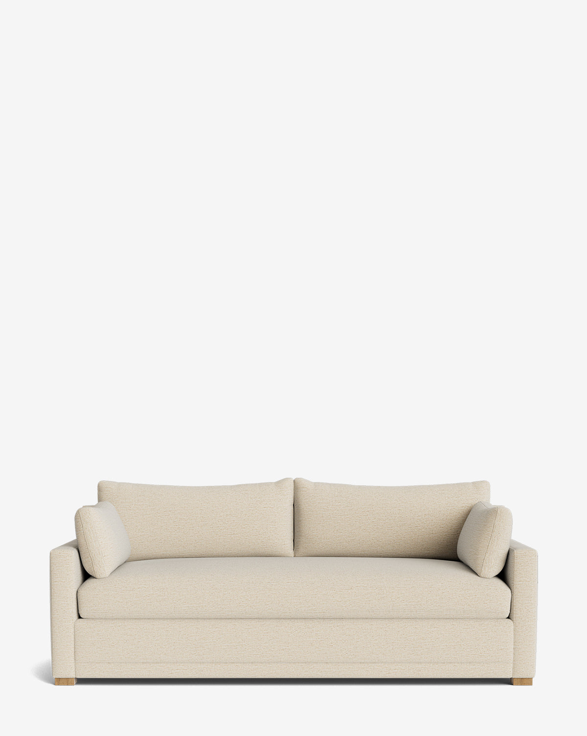 The Peterson Classic Upholstered Sofa (75 - 100) is a modern, handcrafted beige sofa with plush cushions, two seat and back cushions, and two cylindrical pillows, displayed against a plain white background by McGee & Co.