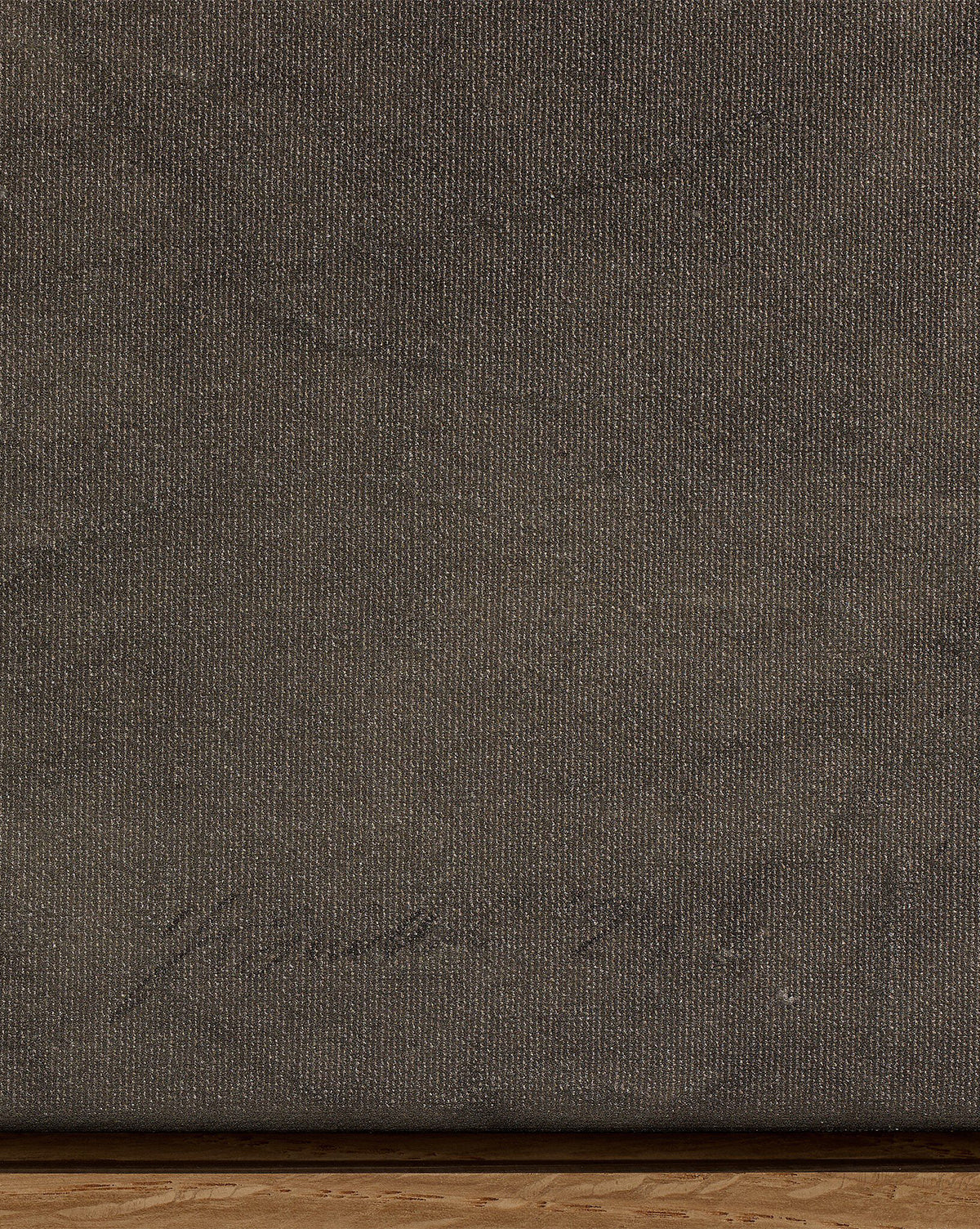 Close-up of Pinecorn III by Kimmy Quillin: a textured dark brown canvas in earthy tones with faint handwriting in the lower left corner and a thin wooden edge visible at the bottom, by McGee & Co.