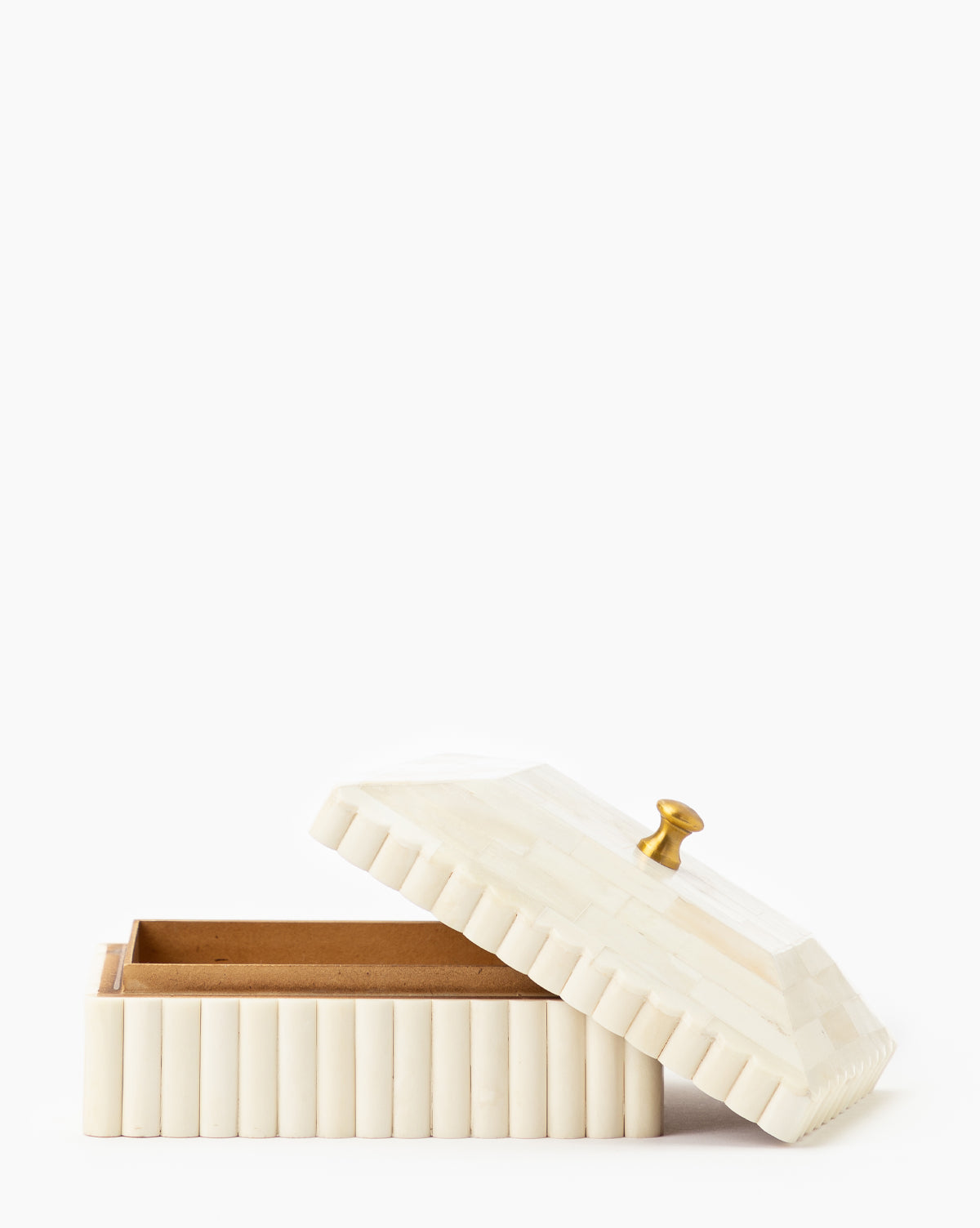 The Plateau Lid Box is a rectangular, cream-colored box with a ribbed exterior, open angled lid, and small gold knob—ideal as a catch-all accessory for designer decor—displayed against a plain white background.