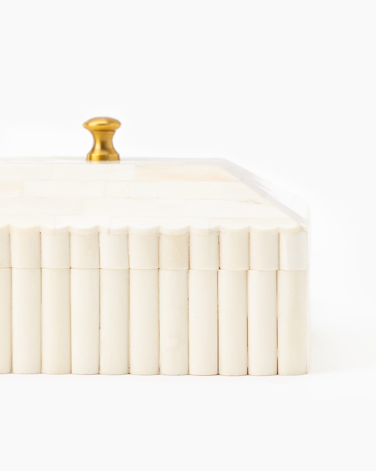 The Plateau Lid Box is a rectangular, ivory container with vertical ridges and a gold knob on the lid—a chic catch-all for designer decor, shown set against a white background.