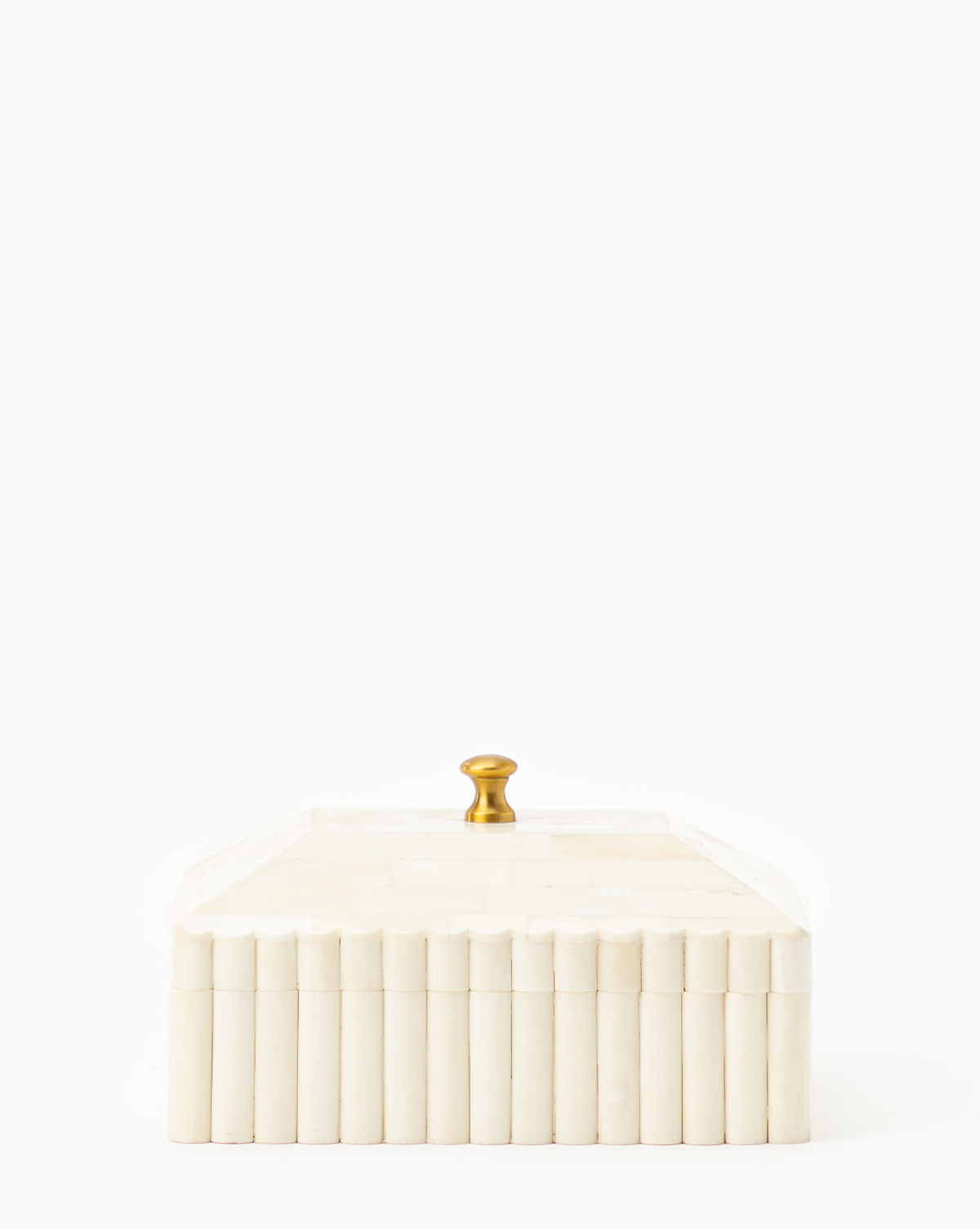 The Plateau Lid Box is a rectangular cream-colored box with vertical ridges and a gold knob, ideal as a stylish catch-all or designer decor piece, shown against a plain white background.