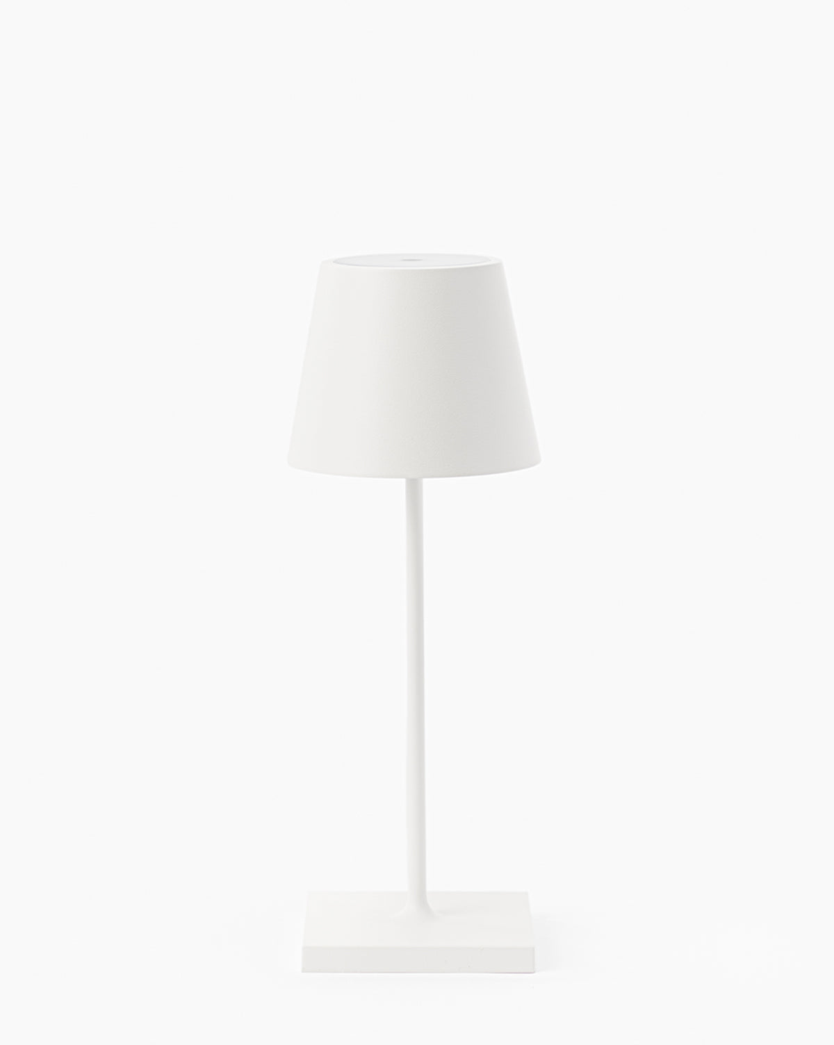 The Poldina Indoor/Outdoor Table Lamp features a minimalist white design with a conical shade and slim stand on a rectangular base, highlighting modern style against a plain white background, by McGee & Co.