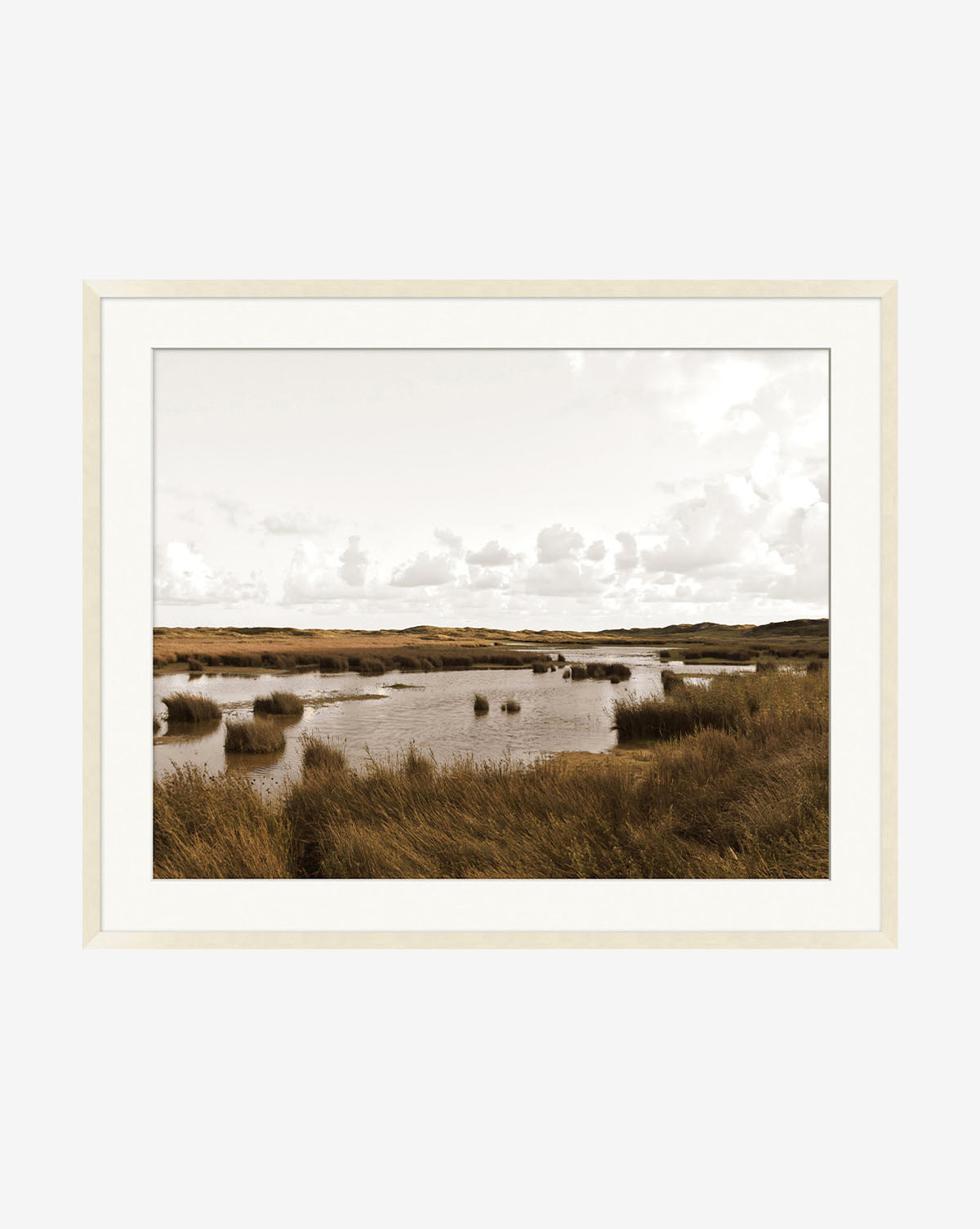The Pond & Meadow framed photograph features a marshland landscape with tall grasses, calm water, and a cloudy sky in neutral tones—ideal wall art presented in a natural glass frame.