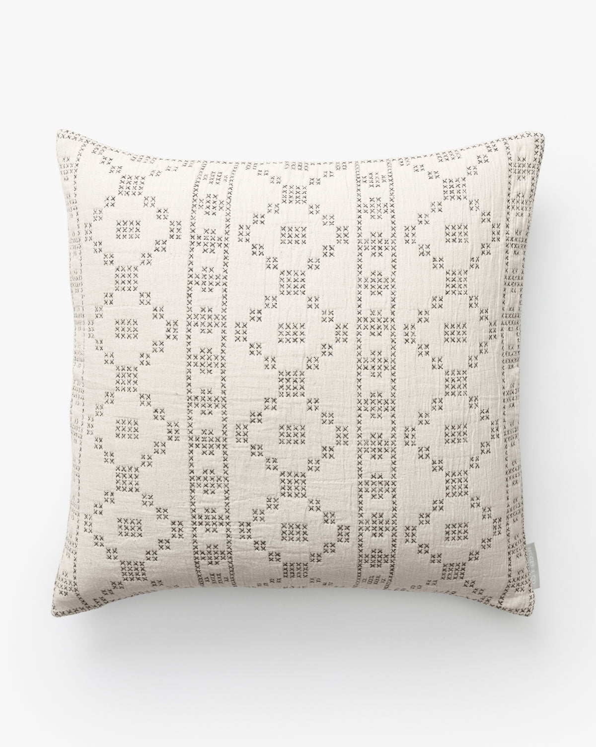 The Prescott Pillow Cover features a cream jacquard backdrop accented by small brown dots and lines forming geometric diamond and square patterns, shown on a white surface by McGee & Co.