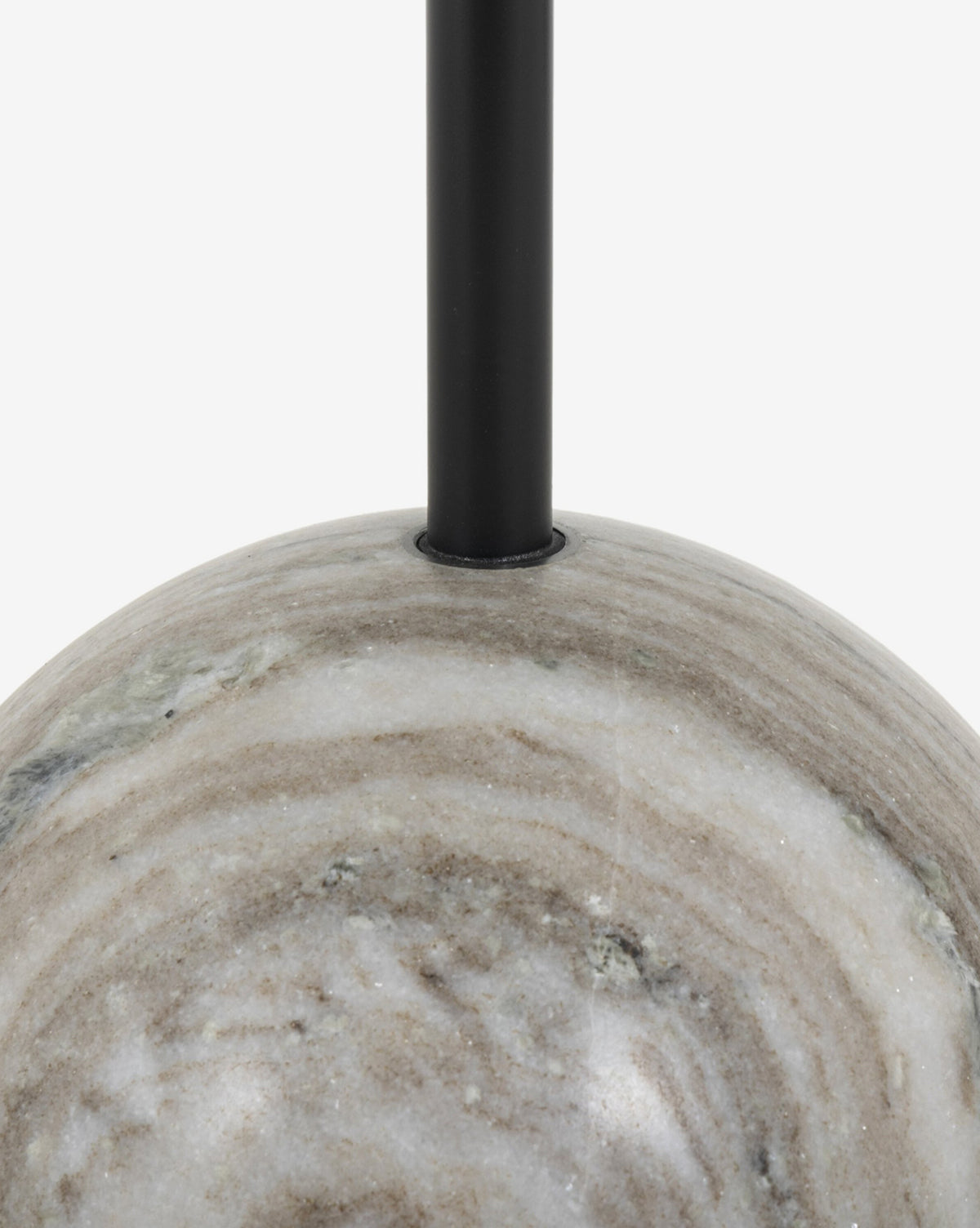 Close-up of the Raelynn End Table’s smooth, round, white marble base with a black metal rod rising from its center—an elegant accent against a plain white background, by McGee & Co.