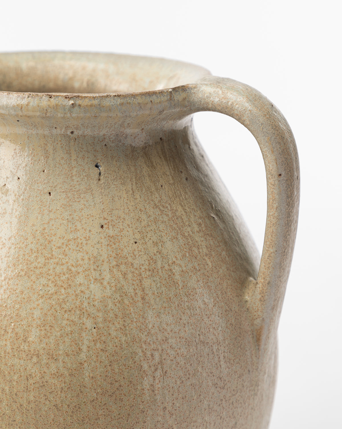 Close-up of the Raiden Vase—a rustic light brown vase with a curved handle and textured, speckled surface—perfect for adding decor charm, set against a white background.