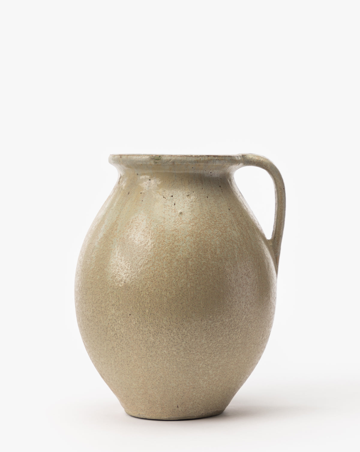 The Raiden Vase is a round, beige ceramic vase with a narrow neck, wide body, and single right-side handle—perfect for adding rustic charm to any plain white background decor.