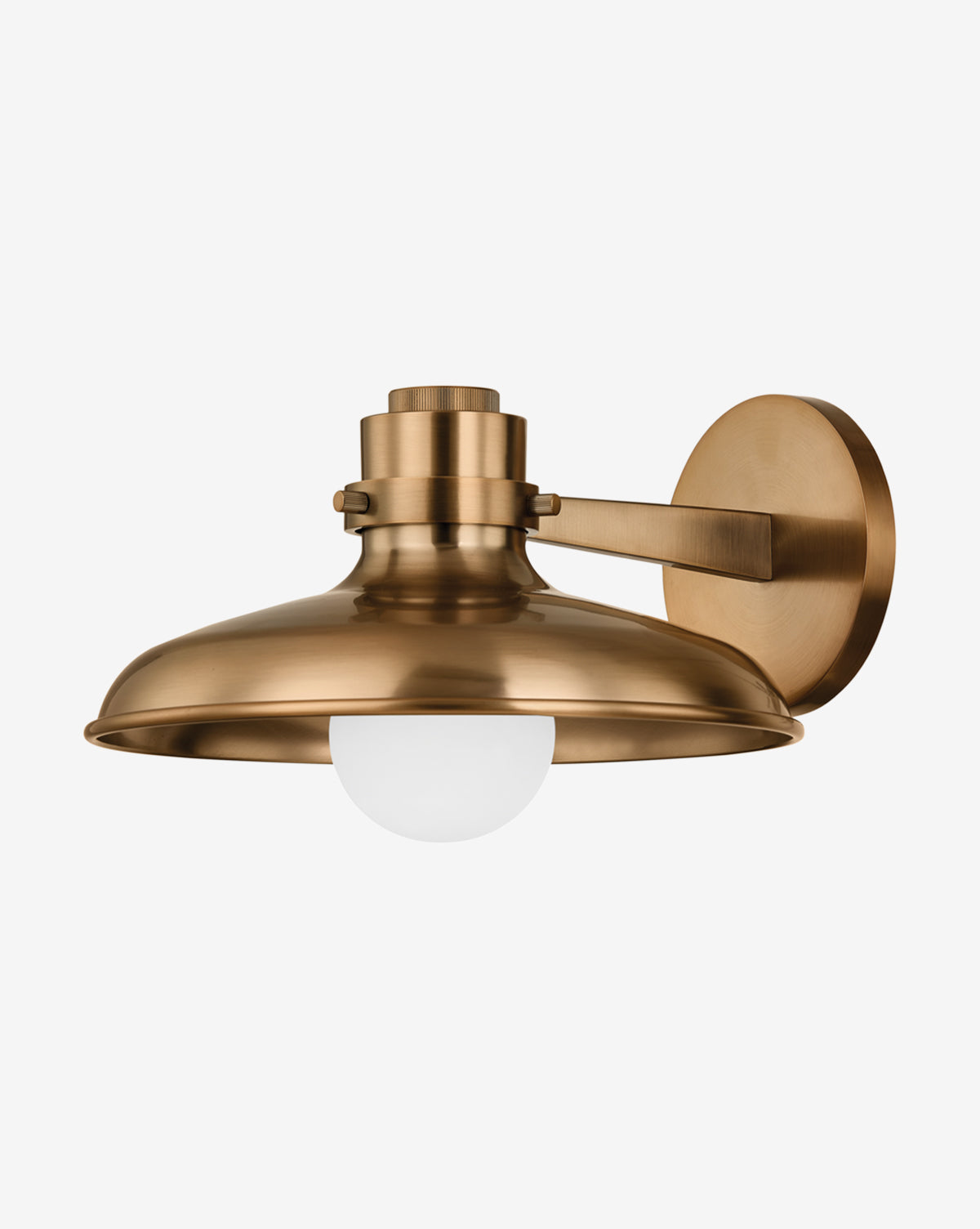 The Rainhill Sconce by Troy Lighting features a wide, dome-shaped patina brass shade and an exposed round white bulb, offering modern industrial style as a wall-mounted fixture by McGee & Co.