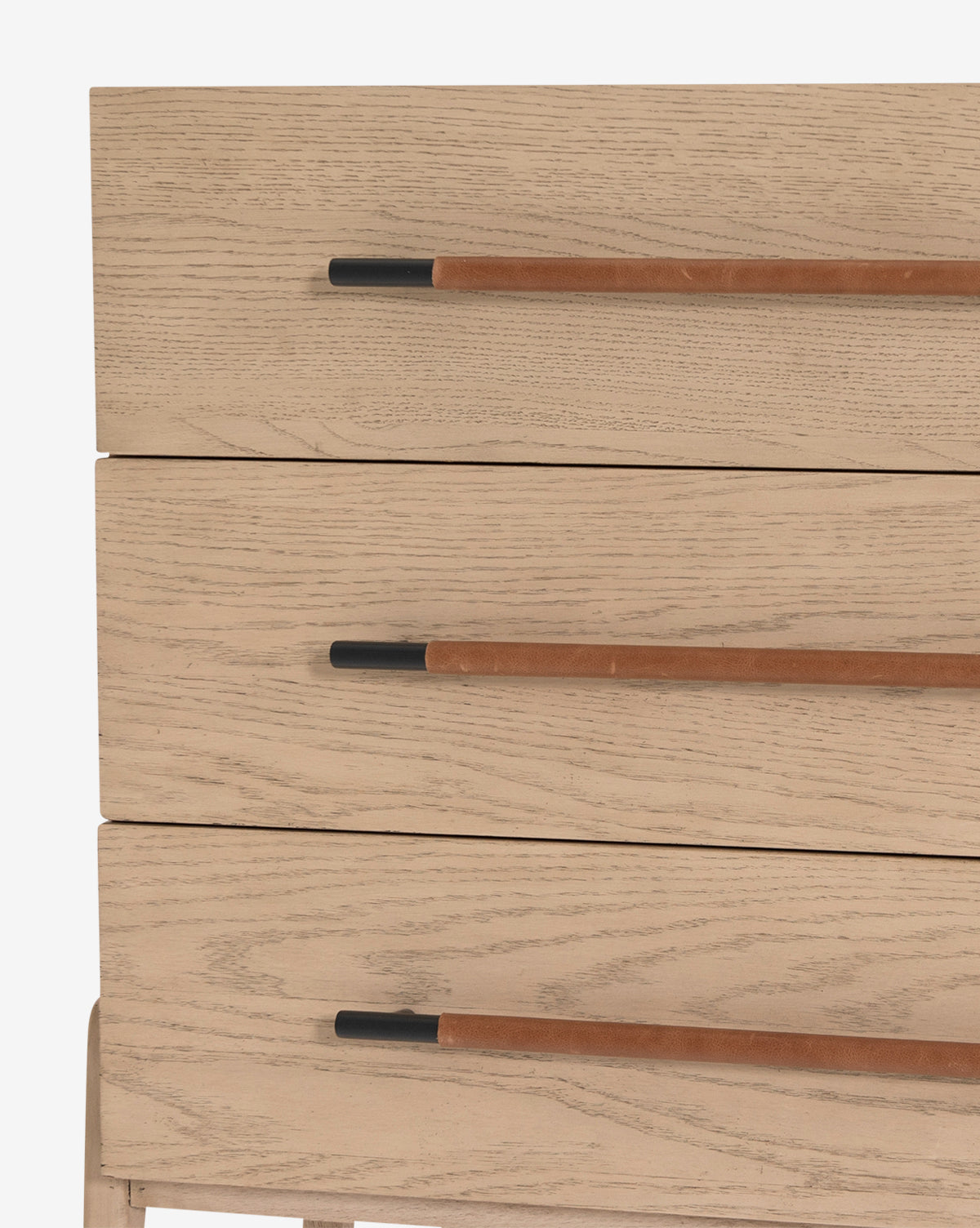 Close-up of three dresser drawers from the Ralston 6-Drawer Dresser, featuring light oak wood, long slim leather pulls with black metal ends, and a minimalist design that highlights the natural wood grain.