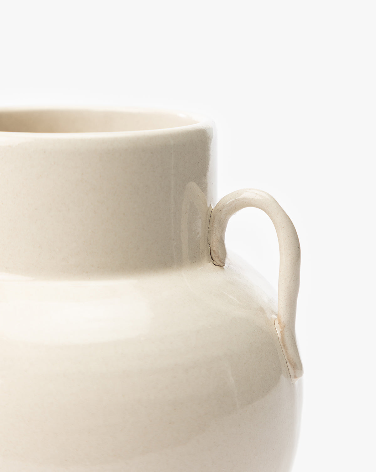 Close-up of the Rasley Handled Jar featuring a cream-colored, curved handle and a smooth, rounded body, set against a plain white background, by McGee & Co.