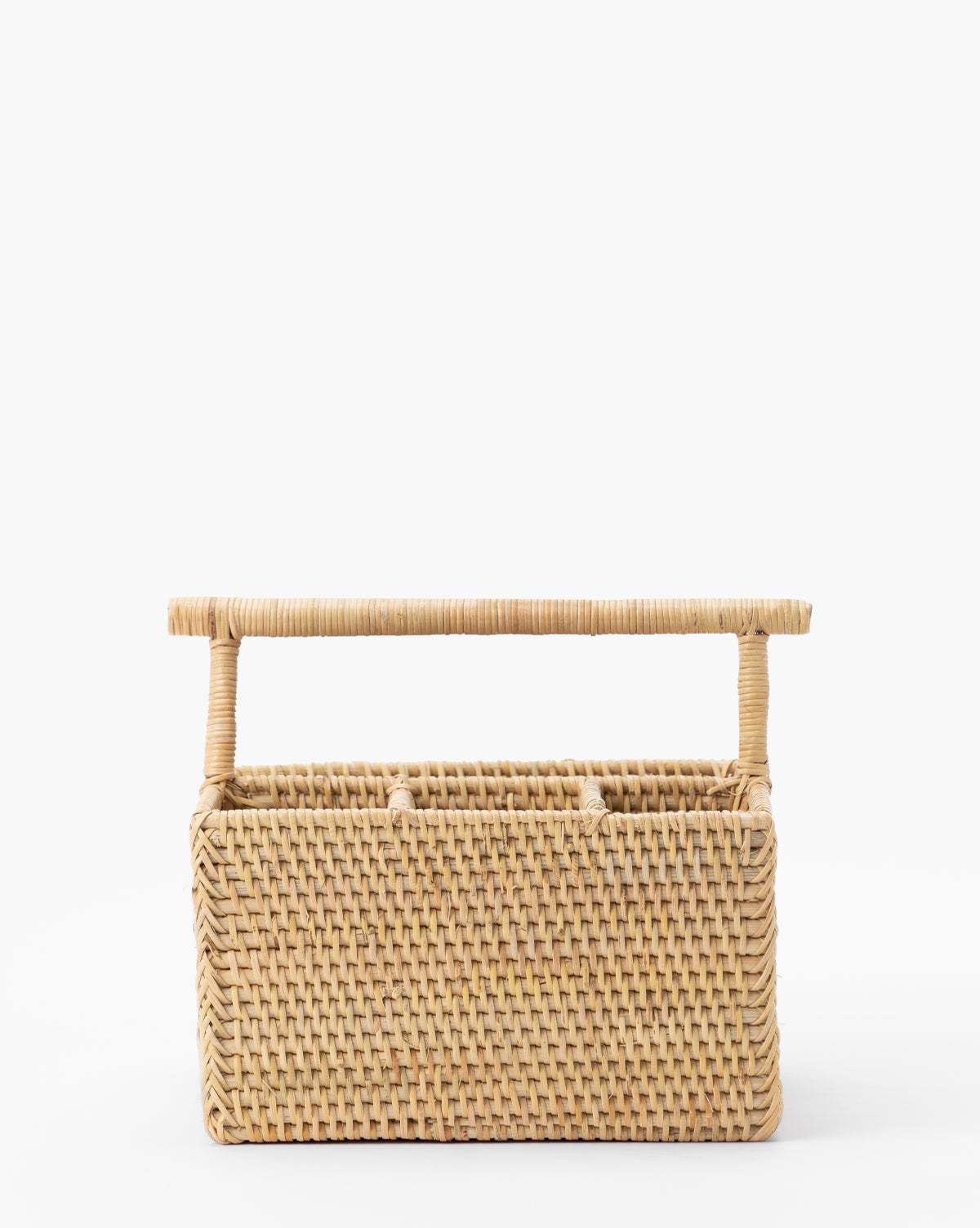 The Rattan Utensil Caddy is a rectangular woven basket in light tan with a sturdy top handle, perfect for organizing flatware, by McGee & Co. Its minimalist design stands out against a plain white background.