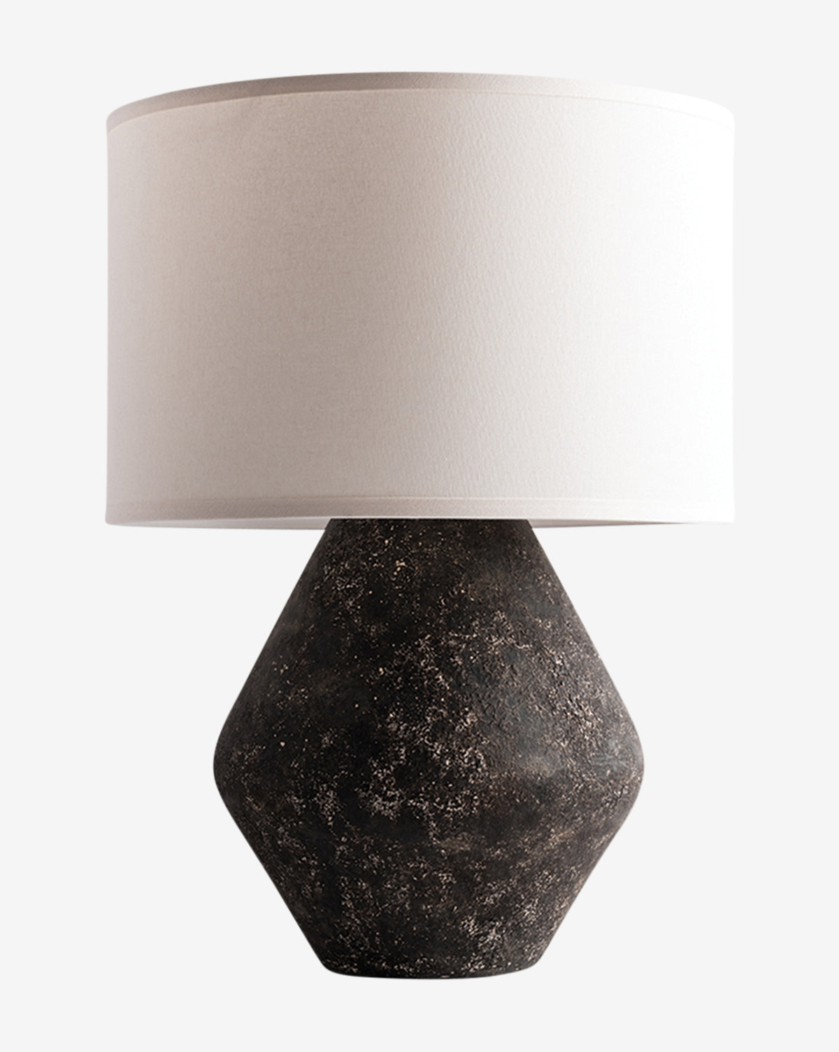 The Rayan Table Lamp by Troy Lighting features a wide white fabric drum shade and a textured dark brown geometric base with a graystone finish, shown on a plain white background. McGee & Co.