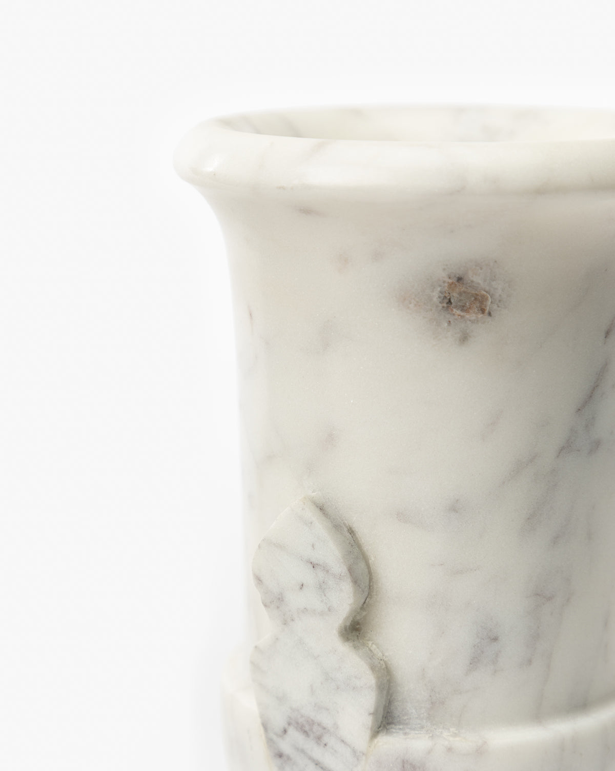 A close-up of the Rayla Marble Vase shows its white marble with grey veins, part of the rim and body, and a small decorative carving—perfect for adding traditional charm to any decor, by McGee & Co.
