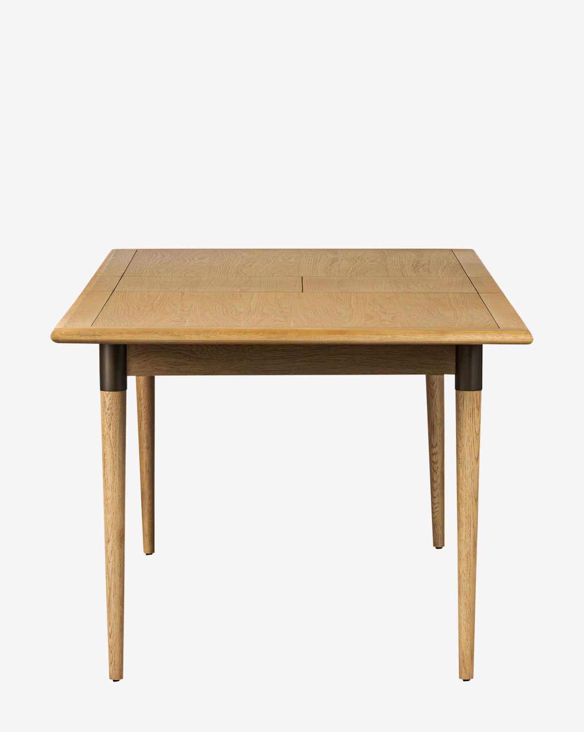 The Redmond Extension Dining Table features a rectangular shape, tapered legs, smooth finish, and visible wood grain for a Scandinavian-inspired look. Shown here against a white background by McGee & Co.