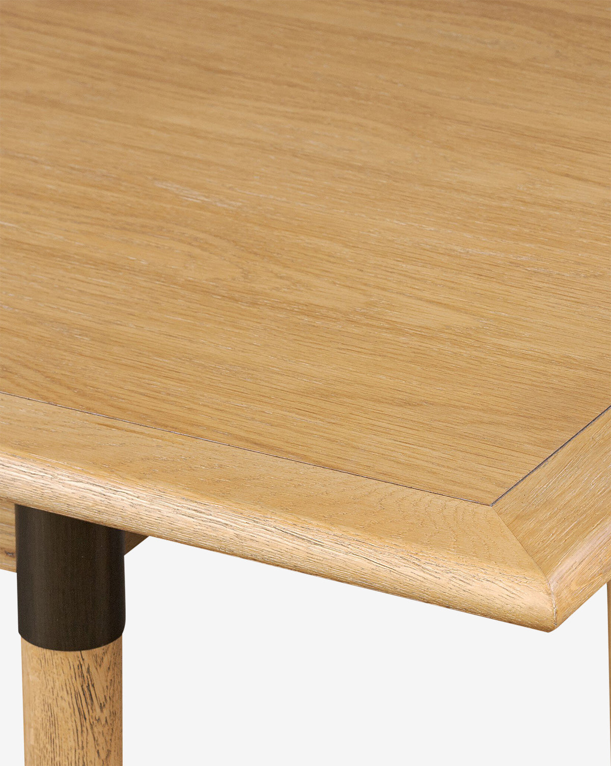 Close-up of the Redmond Extension Dining Table highlights its light wood grain, beveled edge, and distinct round leg—an elegant Scandinavian-inspired design ideal for modern dining spaces, by McGee & Co.
