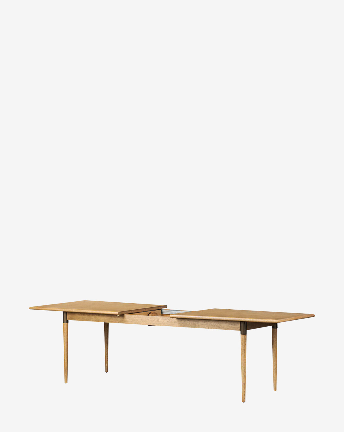 The Redmond Extension Dining Table is a rectangular wooden dining table with tapered legs, shown extended with a central leaf. Its clean Scandinavian design makes it ideal for any dining room. The background is plain white, by McGee & Co.