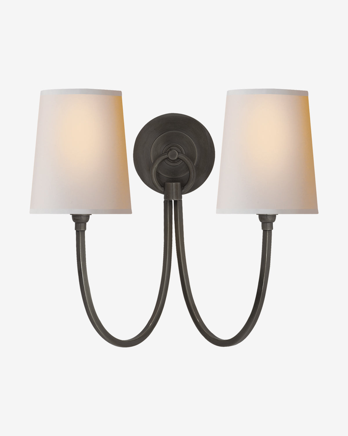 The Reed Double Sconce by Visual Comfort & Co. Signature is a modern wall light with two black metal arms, a round base, and white lampshades that emit a warm glow, available at McGee & Co.