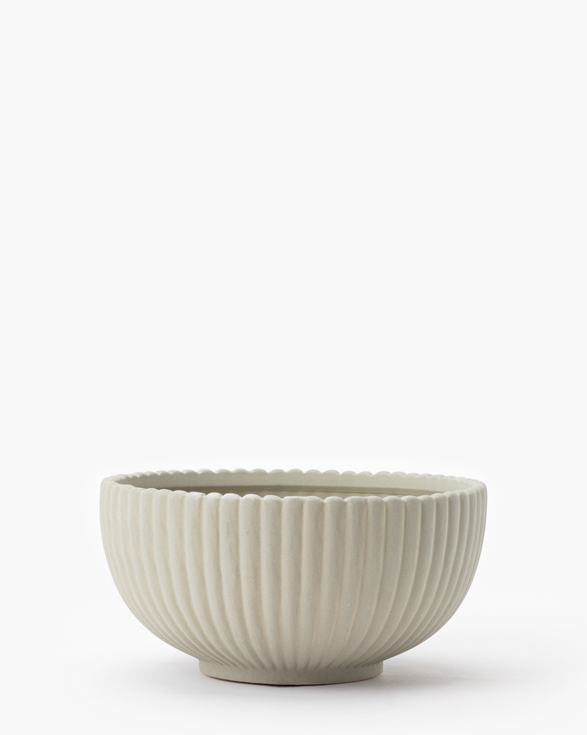 The Reeded Bowl features light gray ceramic with a fluted, ribbed texture and a scalloped rim, shown against a plain white background.