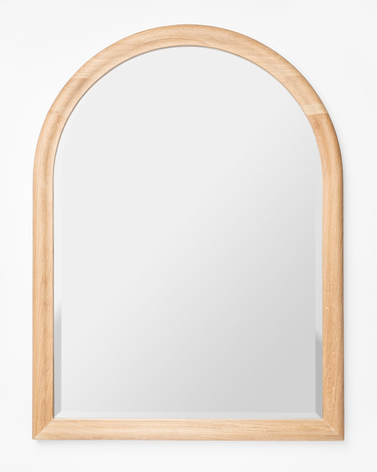 The Reta Arched Wall Mirror features a natural oak wooden frame with a rounded arch top and straight sides and bottom, displayed against a plain white background, by McGee & Co.