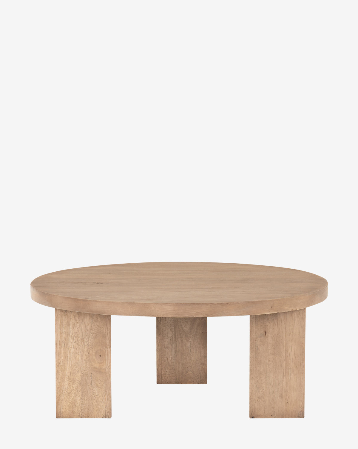 The Rhianne Coffee Table features a modern round top and three wide block legs, expertly crafted from parawood, by McGee & Co. It is displayed on a plain white background.