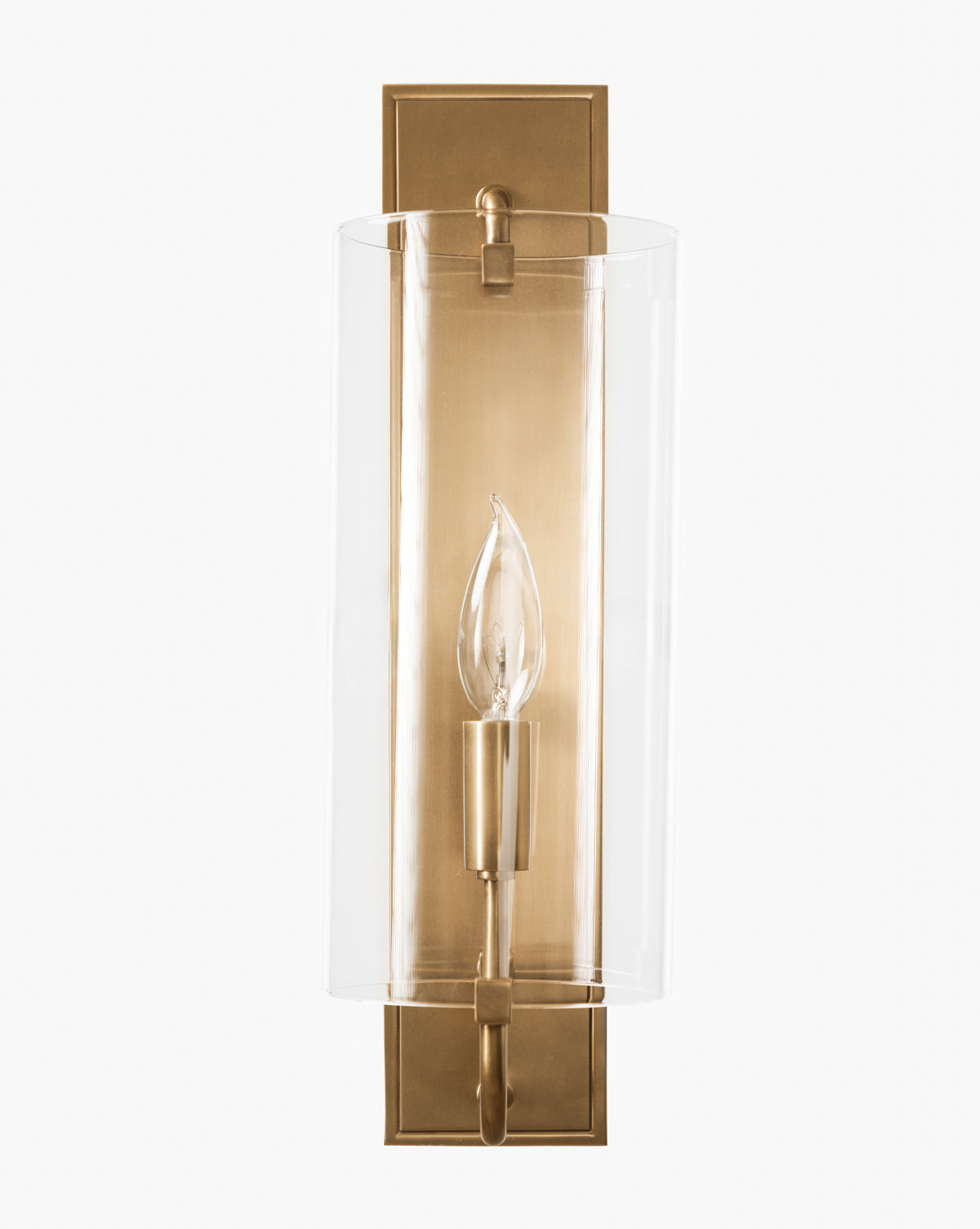 The Rhys Sconce by Meredith (China) Ltd features a wall-mounted brass design with a rectangular backplate, a clear cylindrical glass shade, and a single exposed candle-style bulb—blending timeless elegance with the refined aesthetic of McGee & Co.