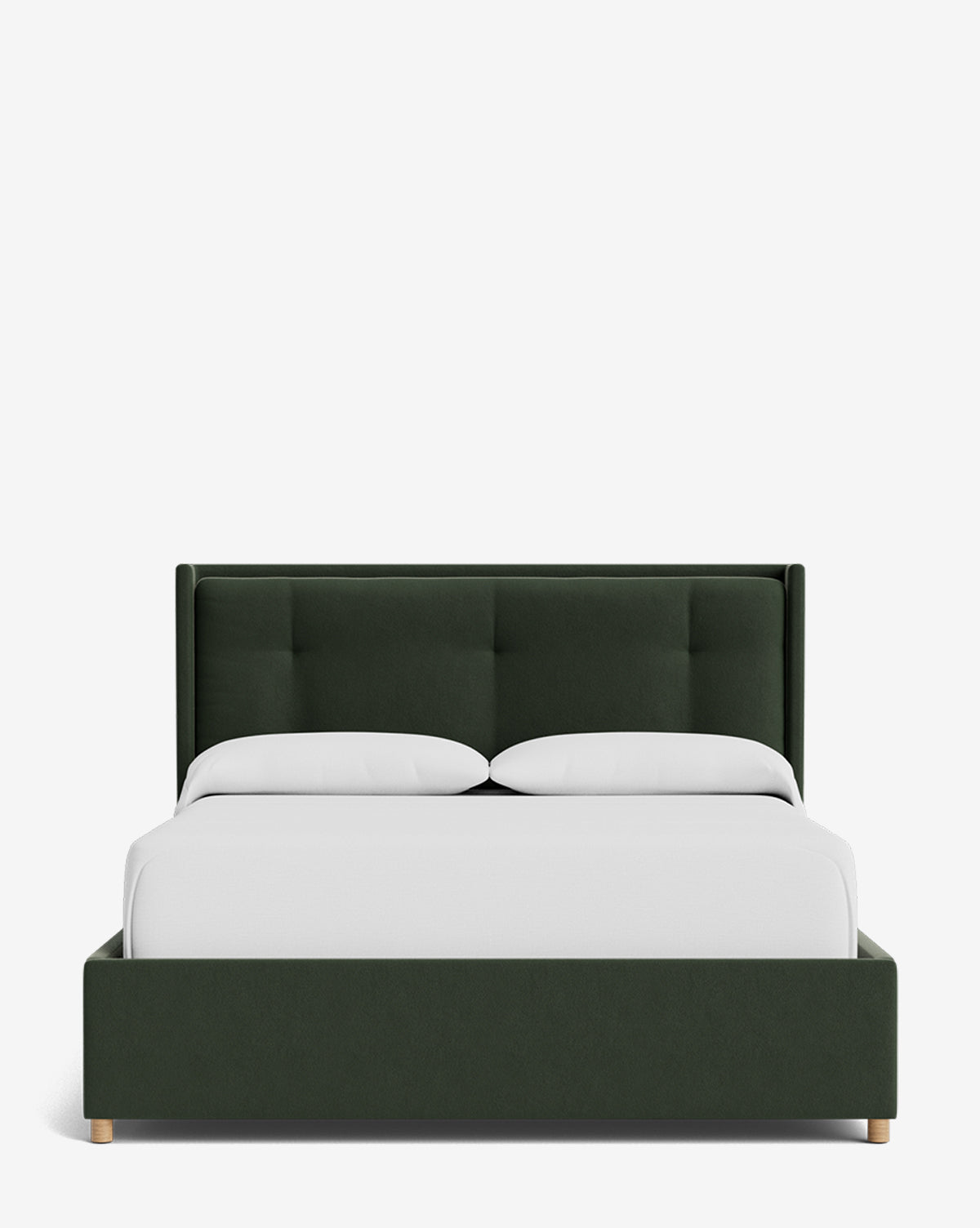 The Ria Bed Low Headboard is a modern dark green upholstered bed with a tufted headboard, neatly dressed in white bedding and two white pillows, shown against a plain white background, by McGee & Co.