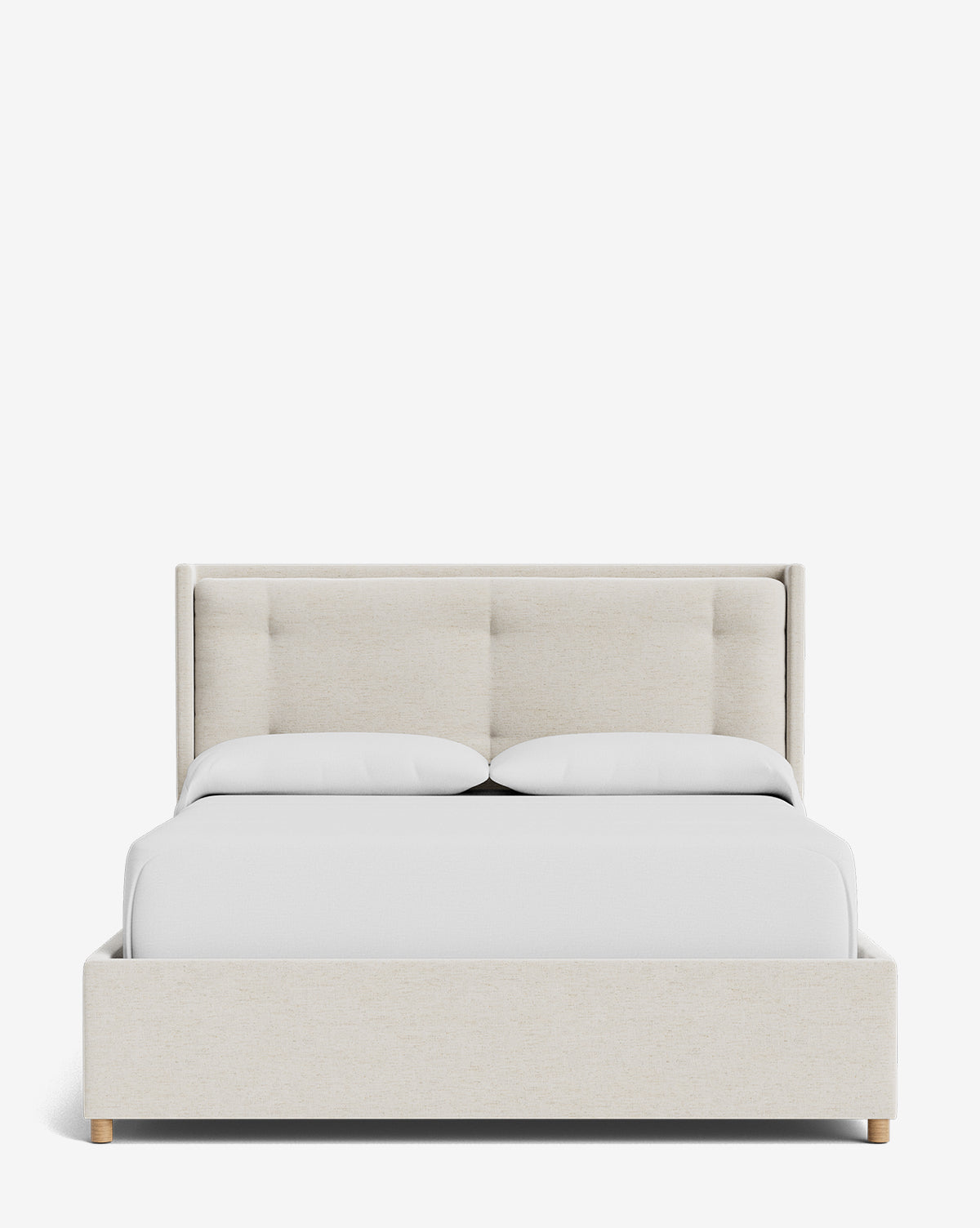 The Ria Bed Low Headboard, shown in light beige upholstery with a tufted headboard, white bedding, and two pillows, is displayed against a plain white background by McGee & Co.