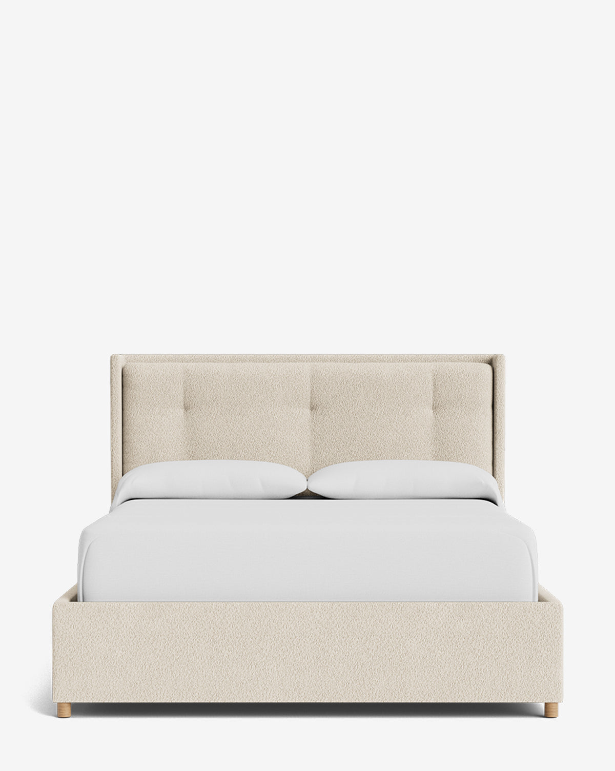 The Ria Bed Low Headboard is a modern beige upholstered bed with a tufted headboard, white bedding, and two pillows, shown from the front against a plain white background, by McGee & Co.