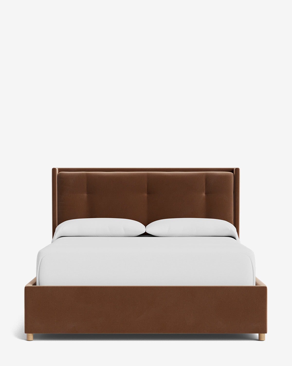 The Ria Bed Low Headboard displays a brown upholstered frame with a tufted headboard, dressed in white bedding and two white pillows, shown from the front on a plain white background by McGee & Co.