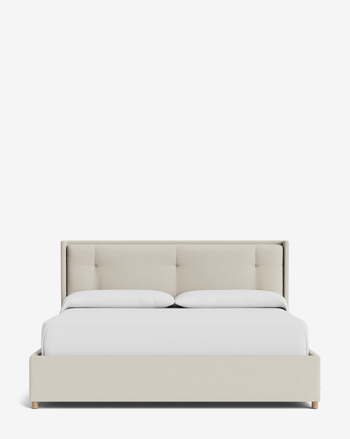 The Ria Bed Low Headboard features a modern beige tufted headboard and frame, styled with two white pillows and a neatly made white comforter, set against a plain white background, by McGee & Co.