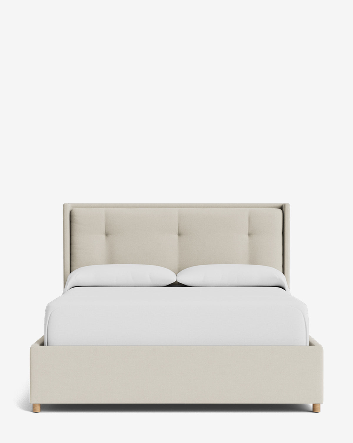 The Ria Bed Low Headboard is a modern upholstered bed with a light beige fabric frame, tufted headboard, white bedding, and light wooden legs, shown on a plain white background by McGee & Co.