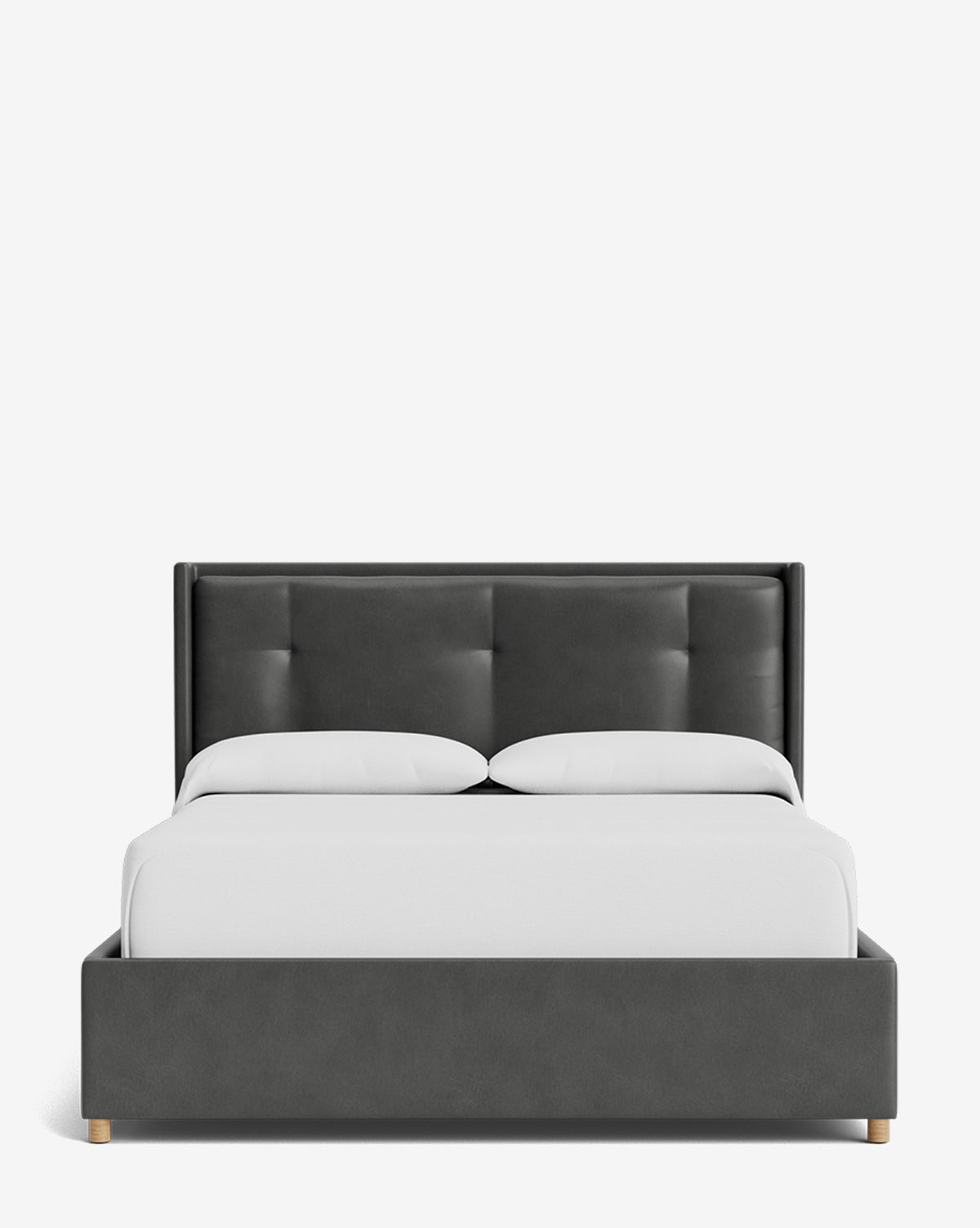 Front view of the Ria Bed Low Headboard, a modern dark gray upholstered bed with a tufted headboard and frame, two white pillows, and a crisp white duvet on a plain white background, by McGee & Co.